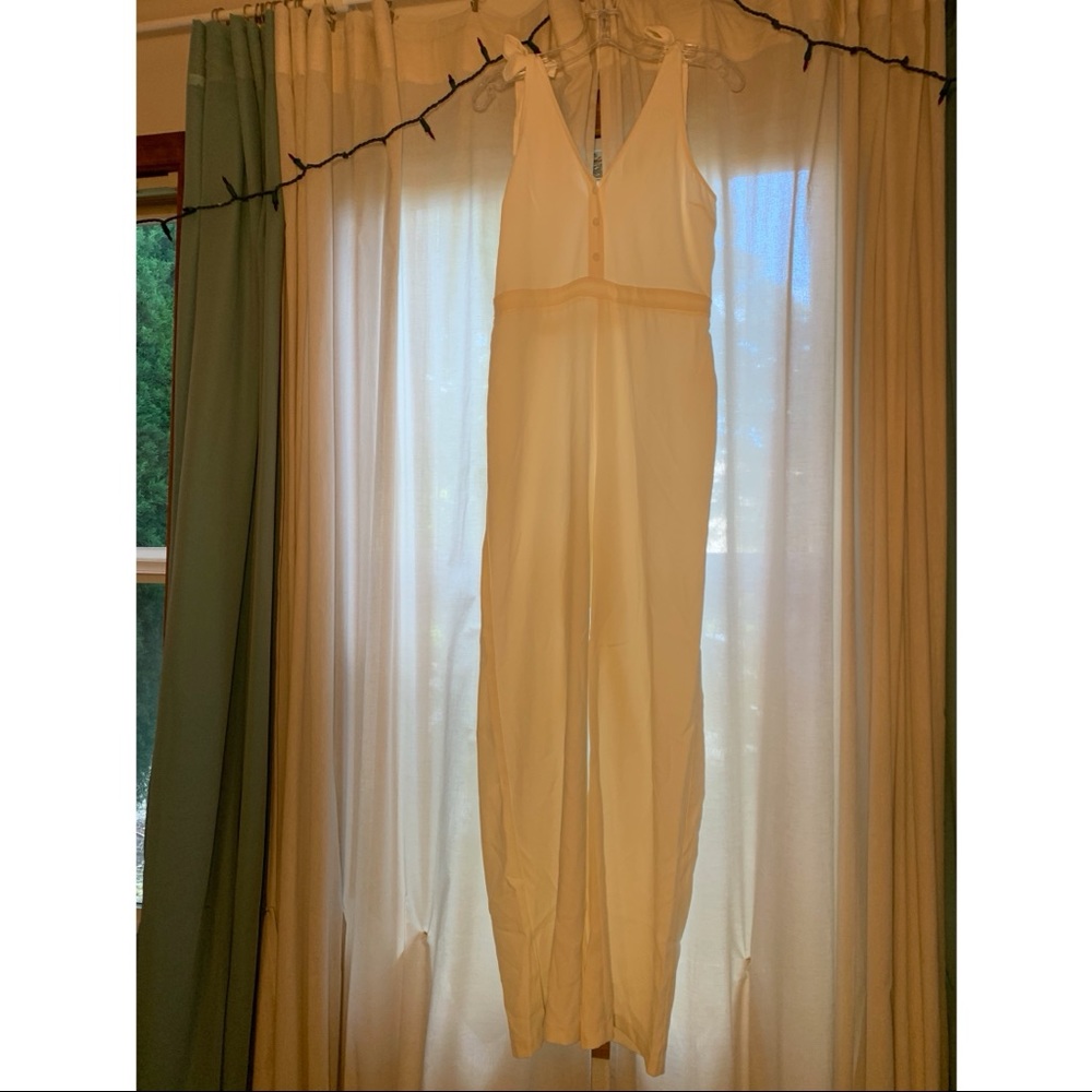 White (poor lighting) jumpsuit. Tie straps. Size Medium.